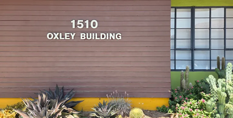 The 1510 Oxley Building, its wood-slat facade fronted by a succulent garden